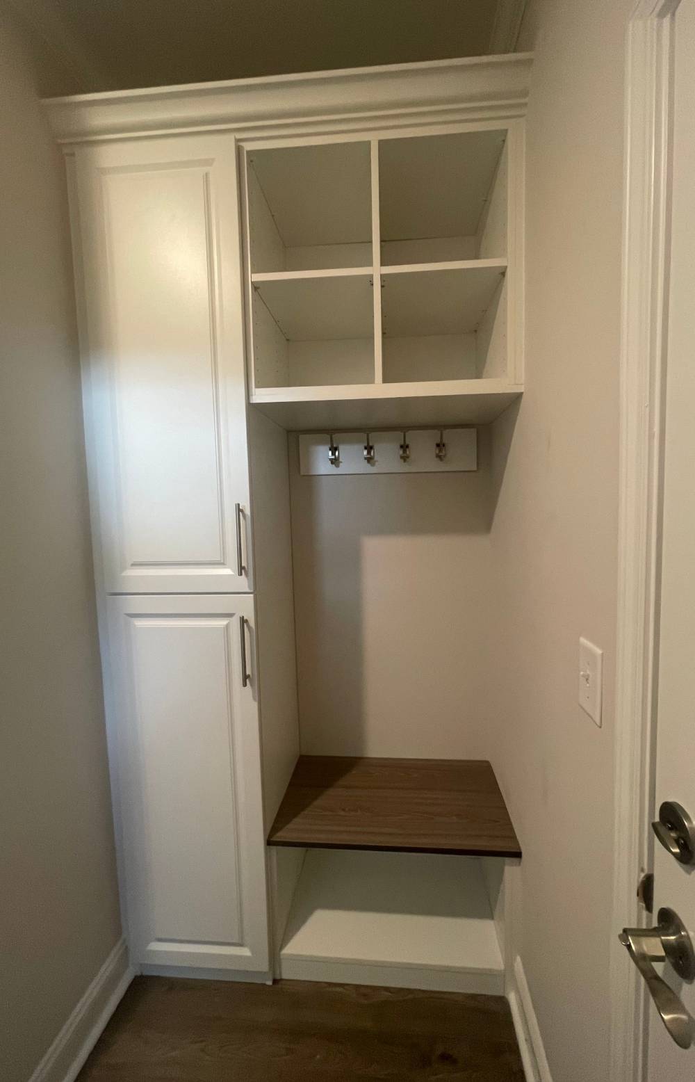 rop zone with upper shelves, bench, cabinet, and coat hooks for entryway.